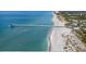 Aerial view of the Gulf Coast showing the beach and a long pier at 12291 Myrtle Bay Ct, Sarasota, FL 34238