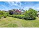 Spacious backyard with a screened-in lanai, green lawn, and lush landscaping at 12291 Myrtle Bay Ct, Sarasota, FL 34238