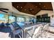 Community clubhouse bar area with multiple seats, granite countertops and ceiling fans at 12291 Myrtle Bay Ct, Sarasota, FL 34238