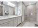 Elegant bathroom features double sinks, a glass-enclosed shower, and neutral finishes at 12291 Myrtle Bay Ct, Sarasota, FL 34238