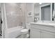 Tiled bathroom featuring a shower-tub combo and white vanity with carrara marble at 12291 Myrtle Bay Ct, Sarasota, FL 34238