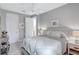 Bright bedroom with ceiling fan, neutral walls, carpet, and crisp white bedding at 12291 Myrtle Bay Ct, Sarasota, FL 34238