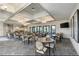 Elegant dining room with round tables, comfortable chairs, and decorative light fixtures at 12291 Myrtle Bay Ct, Sarasota, FL 34238