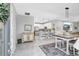 Open concept dining area flowing seamlessly into the kitchen with a stylish table and ample seating at 12291 Myrtle Bay Ct, Sarasota, FL 34238