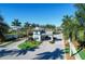 Neighborhood entrance with manned security booth, mature palms, and lush landscaping on a bright, sunny day at 12291 Myrtle Bay Ct, Sarasota, FL 34238
