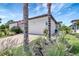 Beautifully landscaped single-story home featuring a two-car garage, paver driveway, and manicured lawn at 12291 Myrtle Bay Ct, Sarasota, FL 34238