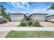 Beautiful single Gathering home with a two car garage, beautiful landscaping and an American flag at 12291 Myrtle Bay Ct, Sarasota, FL 34238