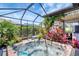 Outdoor hot tub with mature landscaping and a covered lanai creating privacy and shade at 12291 Myrtle Bay Ct, Sarasota, FL 34238