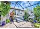 Backyard patio with hot tub, privacy fence, professional landscaping, potted plants, and paver flooring at 12291 Myrtle Bay Ct, Sarasota, FL 34238