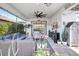 Beautiful covered lanai with comfortable wicker seating, a ceiling fan, and decor with potted plants and a TV at 12291 Myrtle Bay Ct, Sarasota, FL 34238