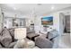 Open-concept living room with modern furnishings, a large sectional sofa, and a flat-screen TV at 12291 Myrtle Bay Ct, Sarasota, FL 34238