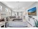 Spacious living room with cozy sectional sofa and open floor plan to the dining area at 12291 Myrtle Bay Ct, Sarasota, FL 34238