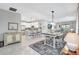 Open-concept living space with dining area, stainless steel appliances, and modern finishes at 12291 Myrtle Bay Ct, Sarasota, FL 34238
