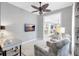 Home office with television, comfortable seating, and view into other parts of the house at 12291 Myrtle Bay Ct, Sarasota, FL 34238