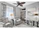 Cozy home office with comfortable seating, a modern desk, and barn doors at 12291 Myrtle Bay Ct, Sarasota, FL 34238