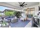 Screened in patio with comfortable wicker furniture and outdoor ceiling fan at 12291 Myrtle Bay Ct, Sarasota, FL 34238