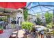 Charming outdoor space with plants and colorful decor under a screened enclosure at 12291 Myrtle Bay Ct, Sarasota, FL 34238