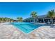 Large pool with a spacious deck surrounded by lounge chairs and lush landscaping at 12291 Myrtle Bay Ct, Sarasota, FL 34238
