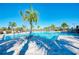 Resort-style pool with palm trees, plenty of lounge chairs and clear blue skies at 12291 Myrtle Bay Ct, Sarasota, FL 34238