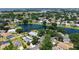 Serene aerial view showcasing a home near a scenic lake and surrounded by lush greenery and other residences at 12339 Hollybush Ter, Lakewood Ranch, FL 34202