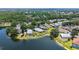Aerial view of property featuring screened pool and lake frontage at 12339 Hollybush Ter, Lakewood Ranch, FL 34202
