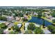 Lovely aerial view displaying a home close to a picturesque lake amid a neighborhood with verdant trees at 12339 Hollybush Ter, Lakewood Ranch, FL 34202