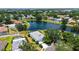 Attractive aerial view presenting a house near a tranquil lake in a community dotted with lush trees at 12339 Hollybush Ter, Lakewood Ranch, FL 34202