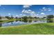 Lush backyard with green grass, mature trees, and beautiful lake at 12339 Hollybush Ter, Lakewood Ranch, FL 34202