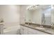 Bathroom with granite countertops, a double sink vanity and a tub with tile surround at 12339 Hollybush Ter, Lakewood Ranch, FL 34202