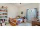 Bedroom featuring natural light, shelving, and a charming bed with a colorful quilt at 12339 Hollybush Ter, Lakewood Ranch, FL 34202