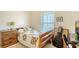 Bedroom with neutral walls and carpet complemented by a wood dresser and a window view at 12339 Hollybush Ter, Lakewood Ranch, FL 34202