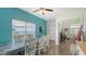 Bright dining room with a contemporary table set, a calming blue accent wall, and natural light at 12339 Hollybush Ter, Lakewood Ranch, FL 34202