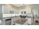Kitchen featuring granite countertops, white cabinets, an island, and stainless steel appliances at 12339 Hollybush Ter, Lakewood Ranch, FL 34202