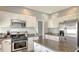 Kitchen featuring granite countertops, white cabinets, an island, and stainless steel appliances at 12339 Hollybush Ter, Lakewood Ranch, FL 34202