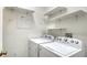 Functional laundry room with a washer, dryer, and floating shelves for extra storage at 12339 Hollybush Ter, Lakewood Ranch, FL 34202