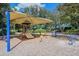 A covered playground area with play equipment on a mulch surface offering fun for  at 12339 Hollybush Ter, Lakewood Ranch, FL 34202