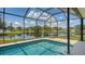 Beautiful screened pool with serene lake view and lush surroundings at 12339 Hollybush Ter, Lakewood Ranch, FL 34202
