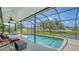 Screened in backyard pool with view of lake and landscaping at 12339 Hollybush Ter, Lakewood Ranch, FL 34202