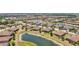 A community is nestled among ponds and trees, boasting well-maintained homes with red tile roofs at 12640 Felice Dr, Venice, FL 34293