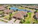 A bird's eye view showcases the home's meticulously maintained lawn, landscaping, and tranquil pond views at 12640 Felice Dr, Venice, FL 34293