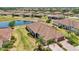 Beautiful aerial view of property showcasing tile roof, pond, landscaping, and community at 12640 Felice Dr, Venice, FL 34293