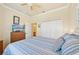Comfortable bedroom with ceiling fan, TV, and en-suite bathroom access at 12640 Felice Dr, Venice, FL 34293