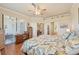 Cozy bedroom with twin beds, a ceiling fan, and natural light from the window at 12640 Felice Dr, Venice, FL 34293