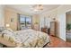 Bright bedroom with two beds, a ceiling fan, and natural light from the window at 12640 Felice Dr, Venice, FL 34293