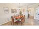 Cozy dining area with wooden table, six chairs, and stylish decorations for Gathering meals at 12640 Felice Dr, Venice, FL 34293