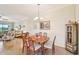 Inviting dining area with a wooden table, seating for six, and an elegant chandelier at 12640 Felice Dr, Venice, FL 34293