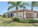 Charming home featuring a tile roof, two-car garage, and mature landscaping with palm trees at 12640 Felice Dr, Venice, FL 34293