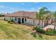 A one-story home boasting a three-car garage, neutral paint, a red tile roof, and meticulously landscaped front yard at 12640 Felice Dr, Venice, FL 34293