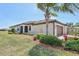 A one-story home with a three-car garage, manicured landscaping, and a neutral color scheme with a red roof at 12640 Felice Dr, Venice, FL 34293