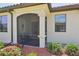 Inviting screened front porch with decorative columns and lush landscaping at 12640 Felice Dr, Venice, FL 34293
